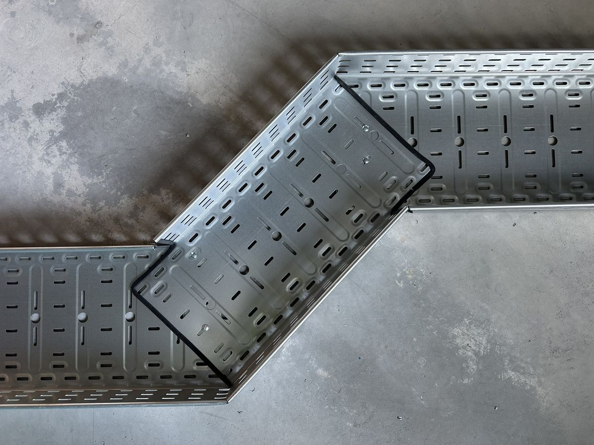 A finished cable tray offset seen from above: two notches, edges covered with protective trim
